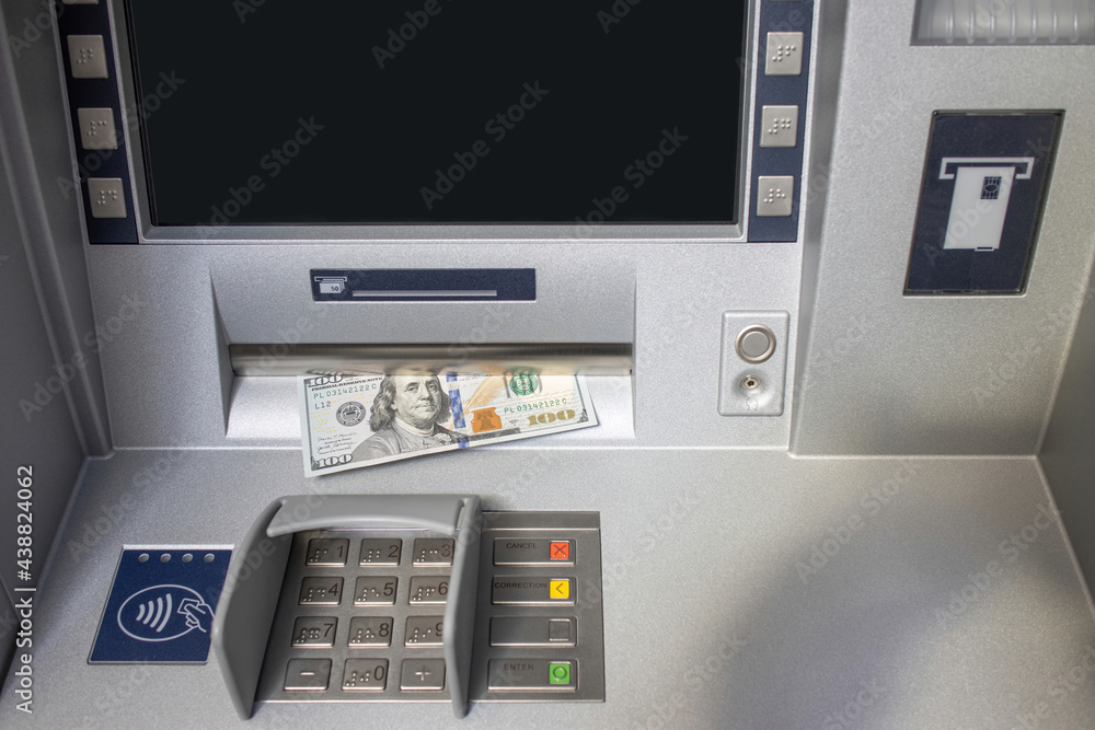 ATM machine with a stuck one hundred dollar bill ATM machine with a stuck one hundred dollar bill
