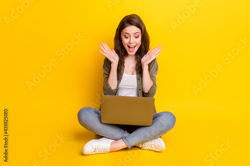 Full length photo of impressed funny lady hands palms up open mouth isolated on yellow color background