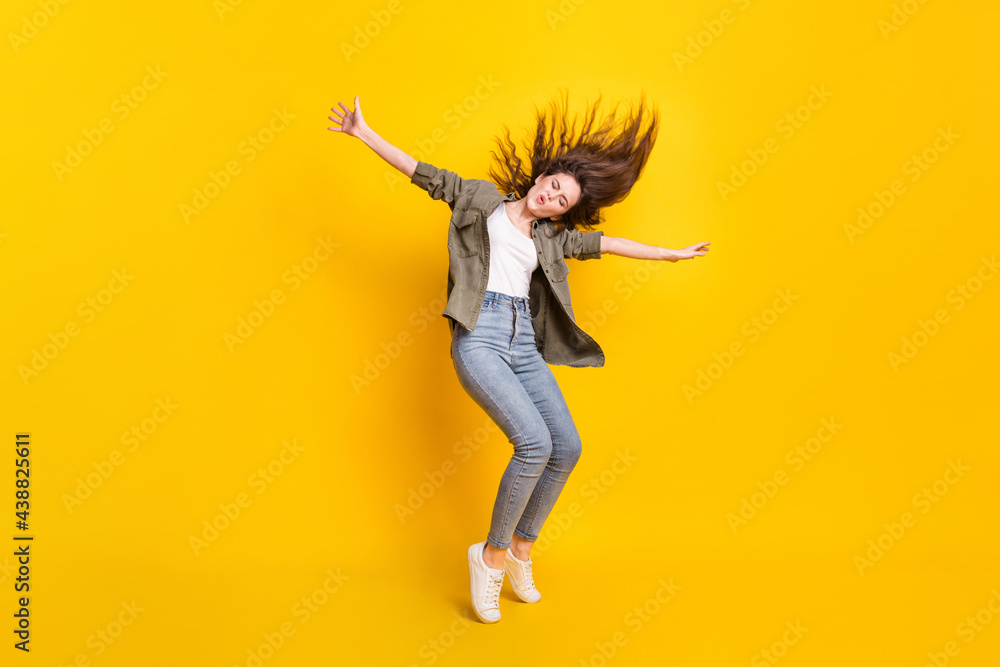 Full size photo of excited satisfied person closed eyes raise arms sides isolated on yellow color background Full size photo of excited satisfied person closed eyes raise arms sides isolated on yellow color background