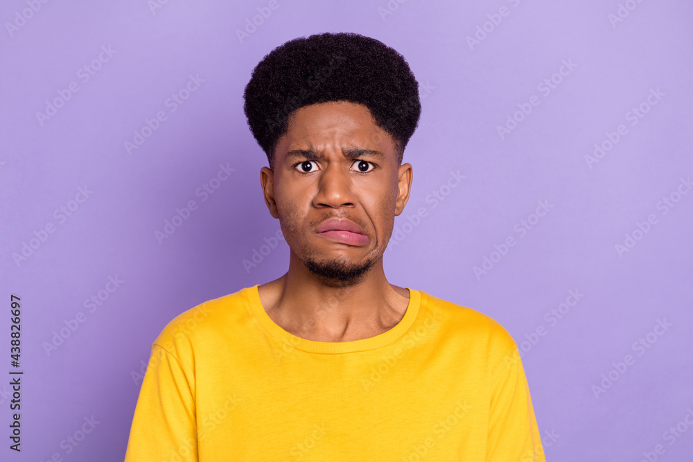 Portrait of attractive moody confused guy bad mood grimacing isolated over violet purple color background Portrait of attractive moody confused guy bad mood grimacing isolated over violet purple color background