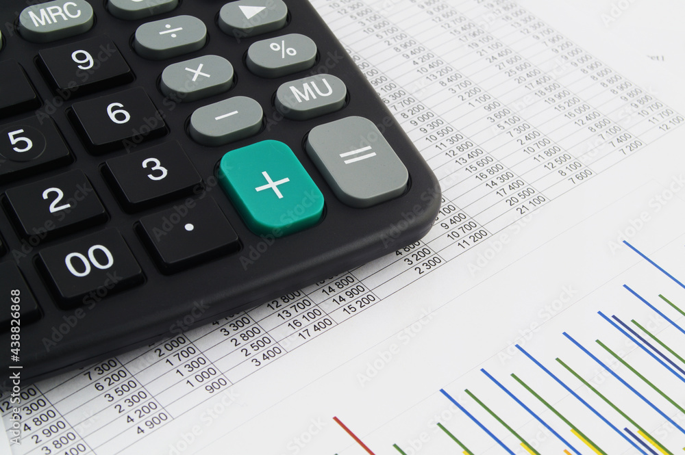 Black calculator on financial documents close up. Concept of business, calculating and accounting. Black calculator on financial documents close up. Concept of business, calculating and accounting.