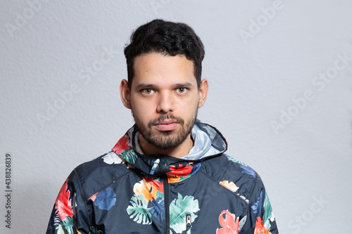 Wallpaper Mural Young latino man frontal portrait in a studio shot. He is serious looking straight to the camera. Torontodigital.ca