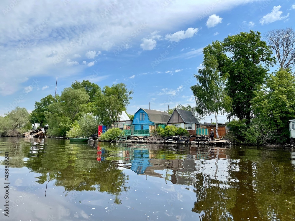 Beautiful landscape. Old country houses on the river bank Beautiful landscape. Old country houses on the river bank