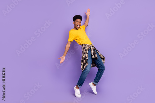 Full length body size view of attractive cheery funky guy dancing clubbing resting good mood isolated over violet purple color background