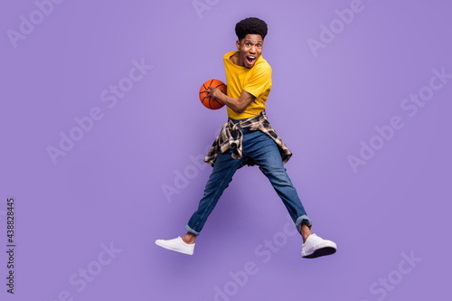 Full length body size view of attractive cheery lucky guy jumping playing game having fun isolated over violet purple color background