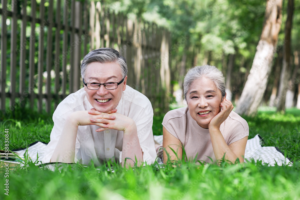 Happy old couple looking at the scenery in the park Happy old couple looking at the scenery in the park