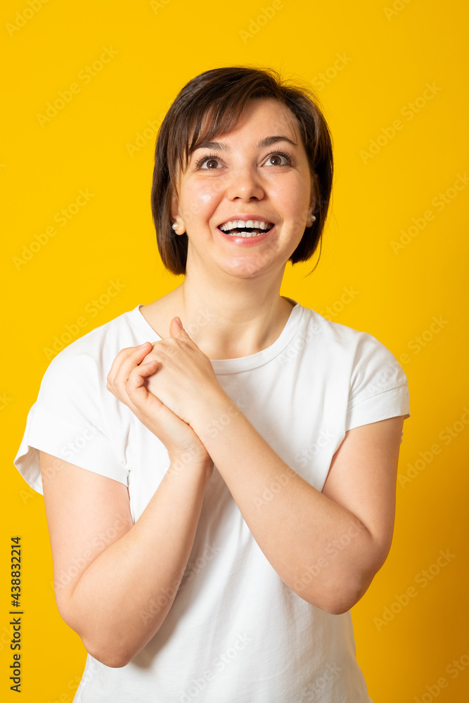 Happy woman. Studio portrait of a smiling woman on a yellow background.. Happy woman. Studio portrait of a smiling woman on a yellow background..