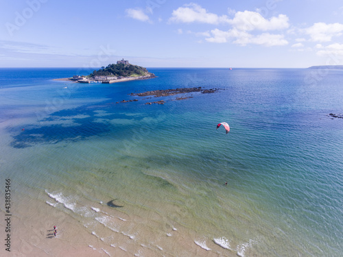A kite surfer in the sea with St MIchaels Mount (Cornwall, England) behind
