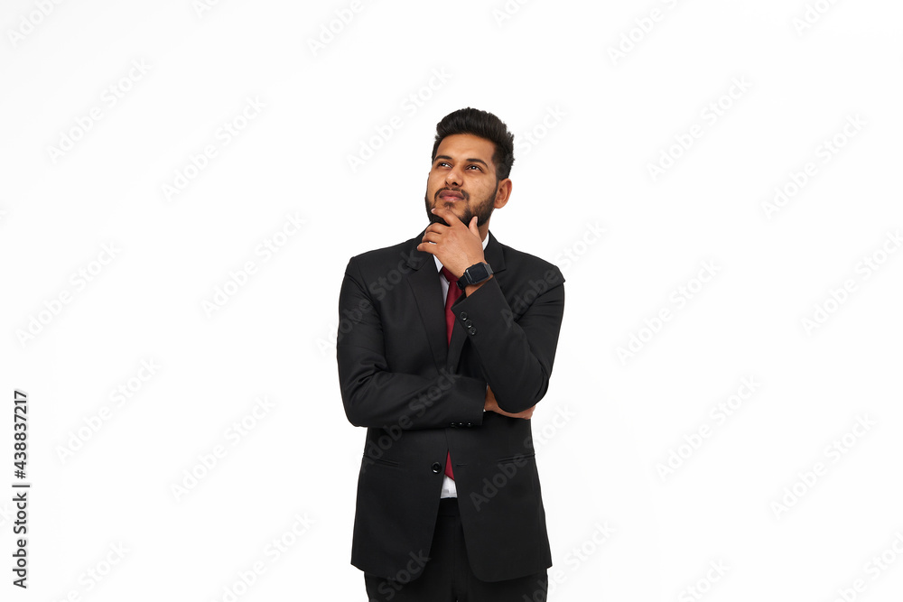 Portrait of young thinking indian top manager in black suit on white isolated background Portrait of young thinking indian top manager in black suit on white isolated background