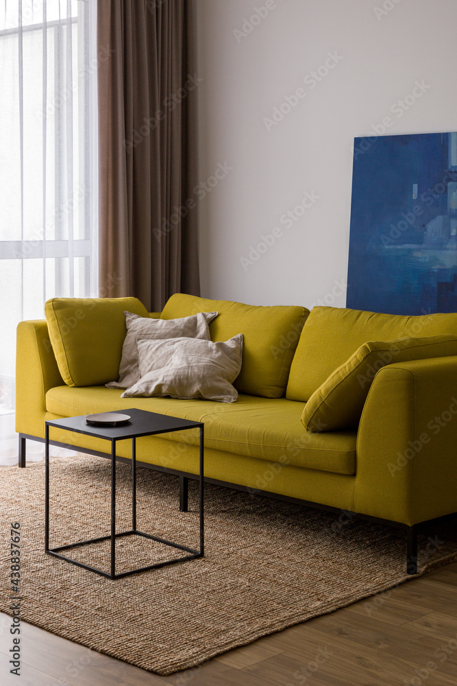 Modern yellow sofa in bright living room StockFoto Adobe Stock