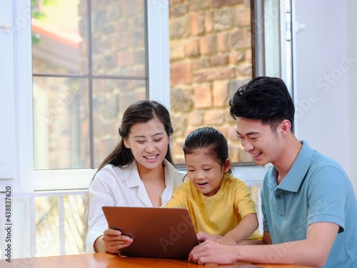 A Happy family of three using laptop