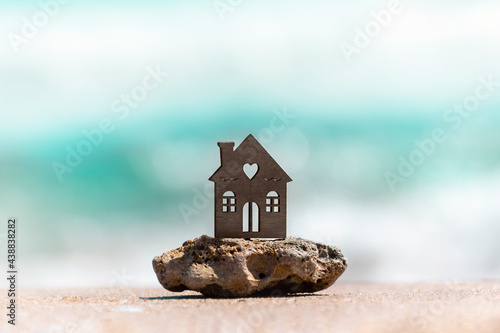 Canvas Print House on sea beach symbol of dream real estate, family vacation, seaside resort