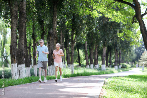 Old couple jogging in outdoor park