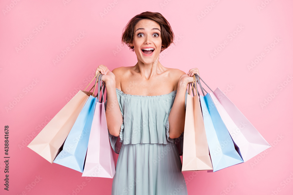 Photo of young excited girl happy positive smile surprised shopping bags black friday sale isolated over pastel color background