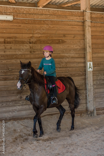 pretty girl during a riding lesson