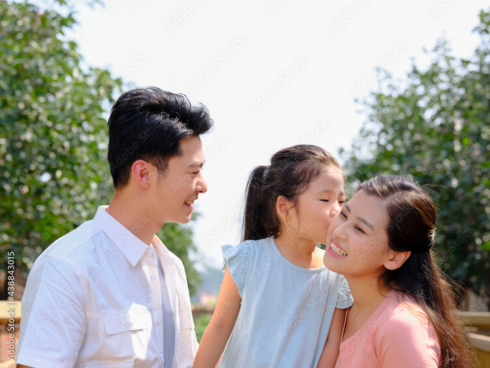 Happy family of three in the outdoor group photo Happy family of three in the outdoor group photo