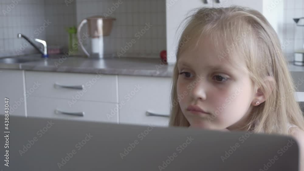 Schoolgirl using laptop home Schoolgirl using laptop home
