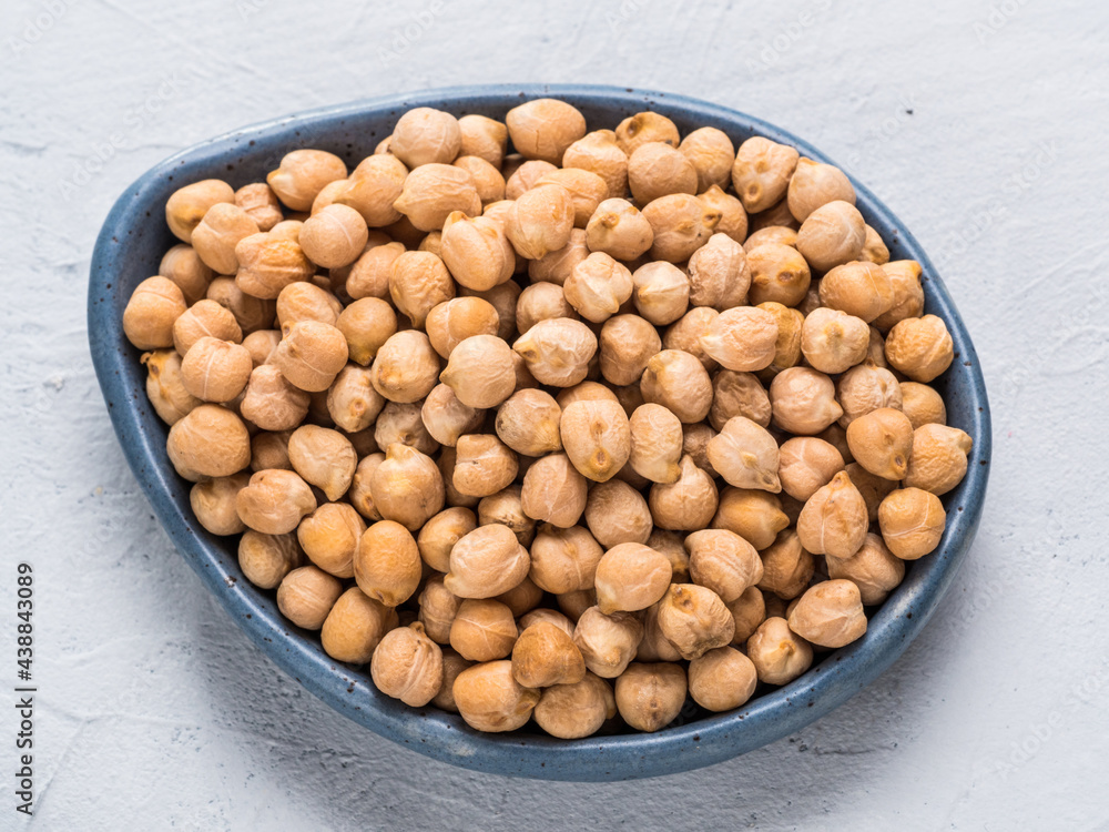 Top view of raw chickpea in plate on gray concrete background Top view of raw chickpea in plate on gray concrete background