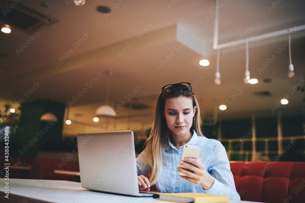 Serious woman text messaging on smartphone Serious woman text messaging on smartphone