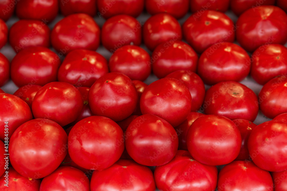 Lots of fresh juicy tomatoes on the market counter. Healthy food, vitamins and veganism. Top view. Lots of fresh juicy tomatoes on the market counter. Healthy food, vitamins and veganism. Top view.