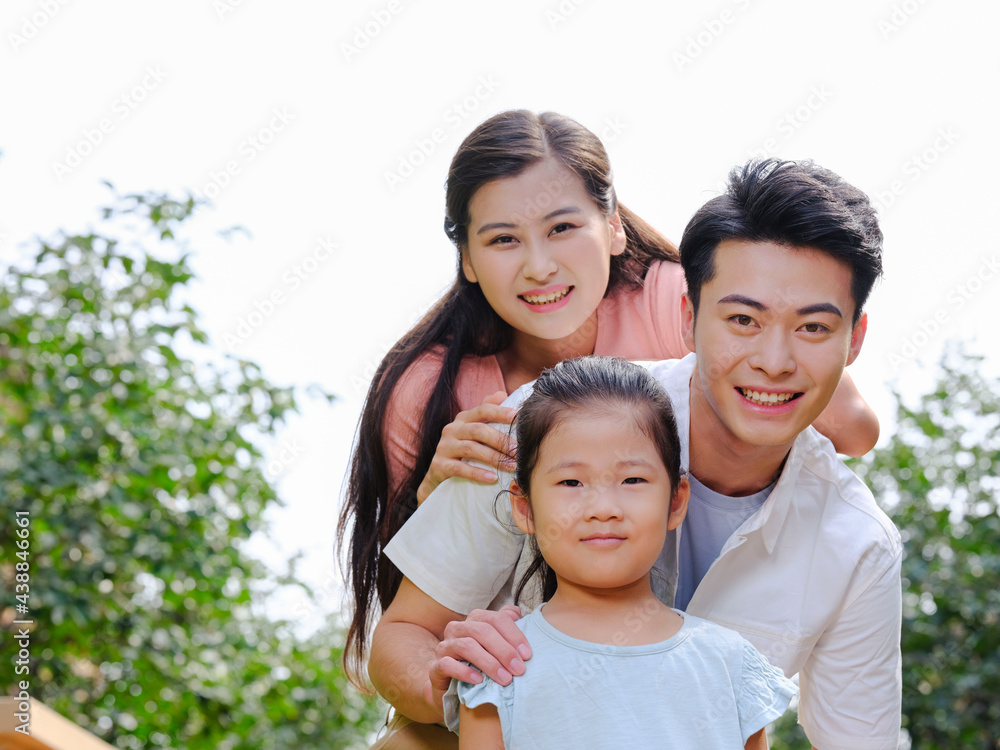 Happy family of three in the outdoor group photo Happy family of three in the outdoor group photo