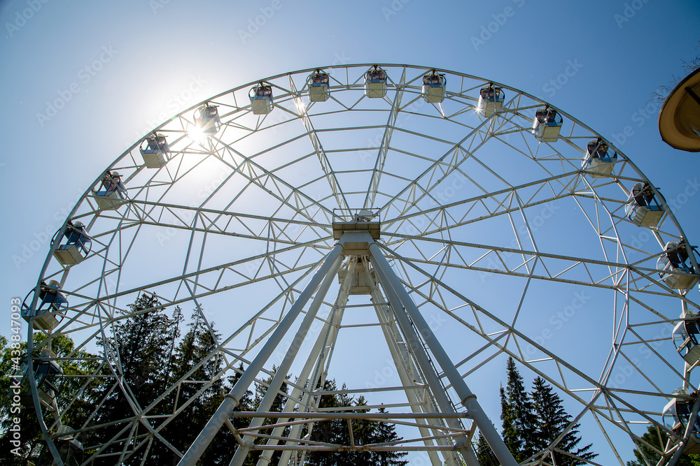 Ferris wheel in city park on a clear summer day