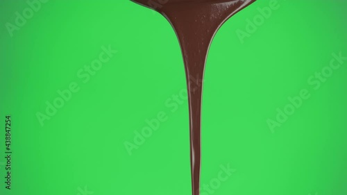Stream of melted dark chocolate pouring on a green screen background, chroma key. Template for motion design or advertising.