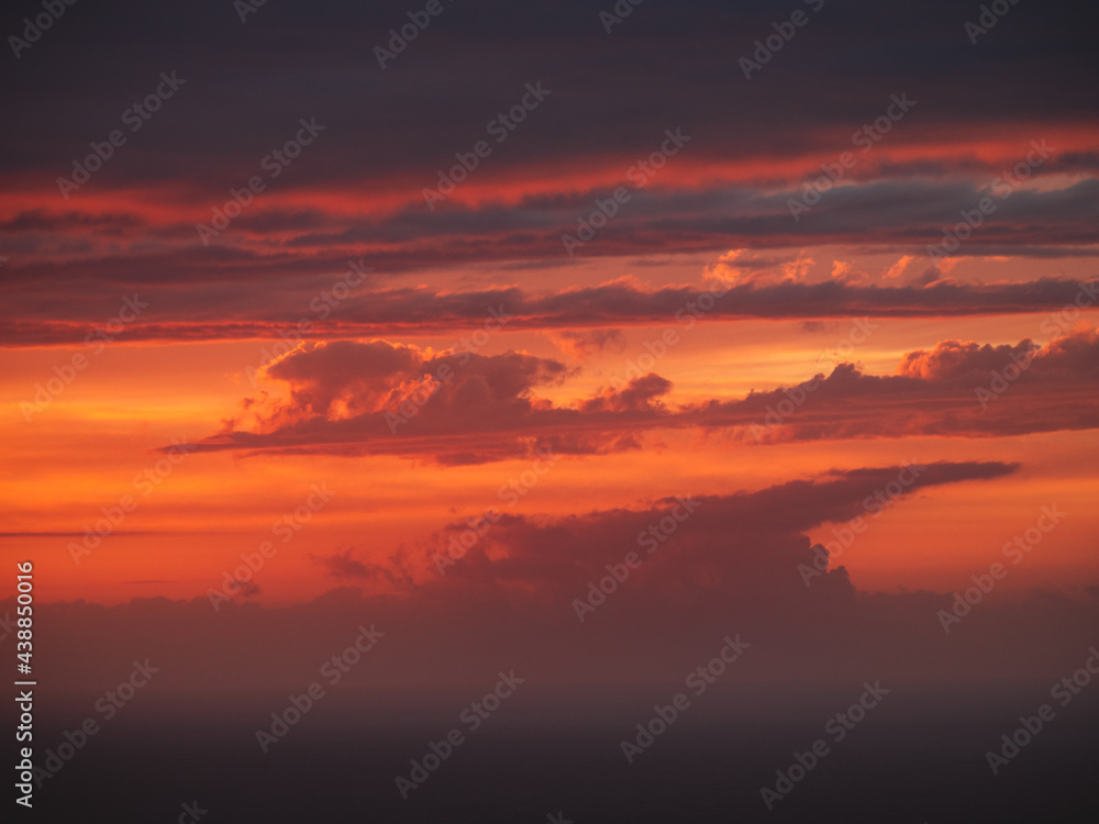 Beautiful burning clouds above the horizon during sunset