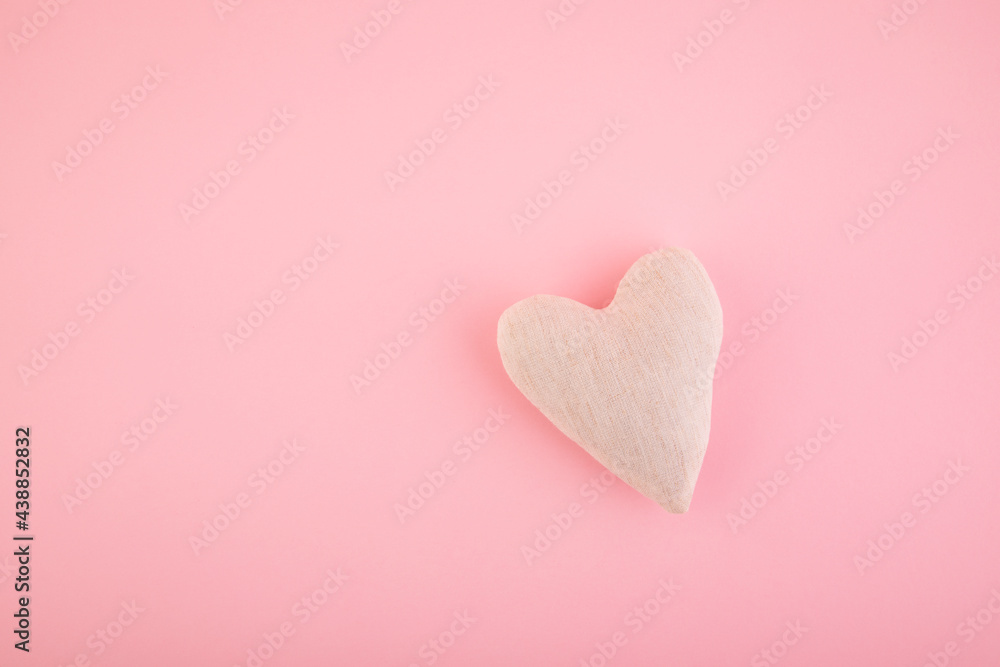 Small white heart on pink background