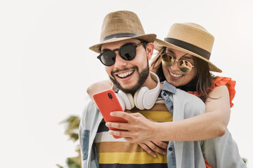 Happy latin people having fun doing selfie outdoor in the city - Tourist lovers and travel concept - Focus on man face