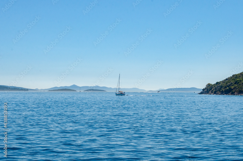 Boat floating over adriatic sea near Slano, Croatia during sunny summer morning, calm and relaxing view from boat trip. Boat floating over adriatic sea near Slano, Croatia during sunny summer morning, calm and relaxing view from boat trip.