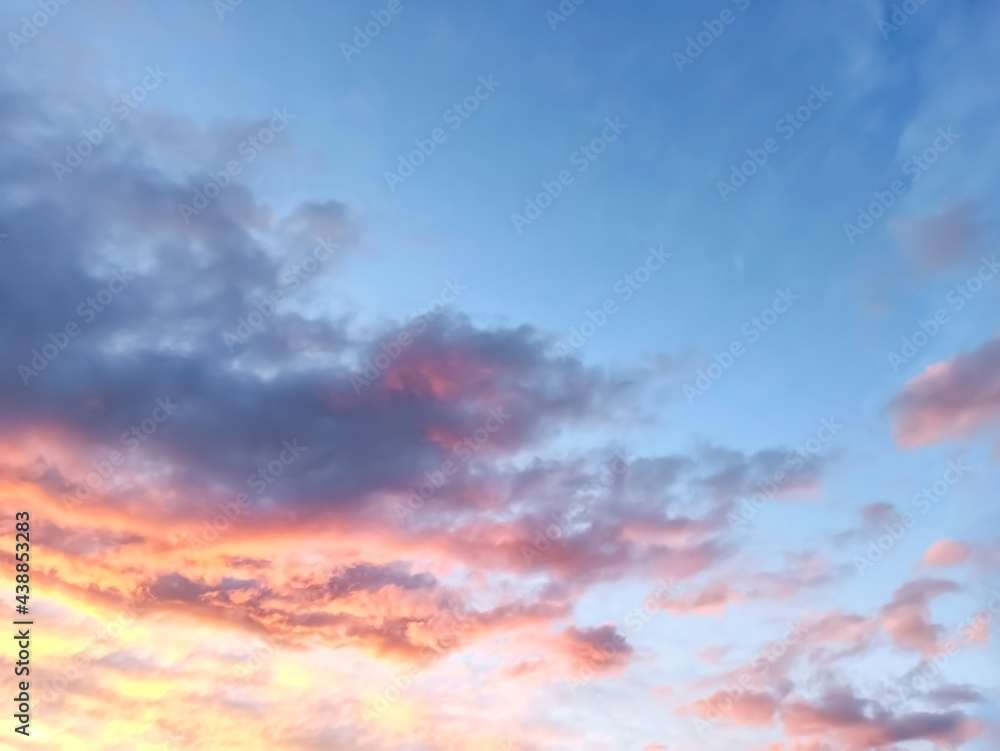 the background of the sunset blue sky with orange pink clouds. beautiful sky landscape.