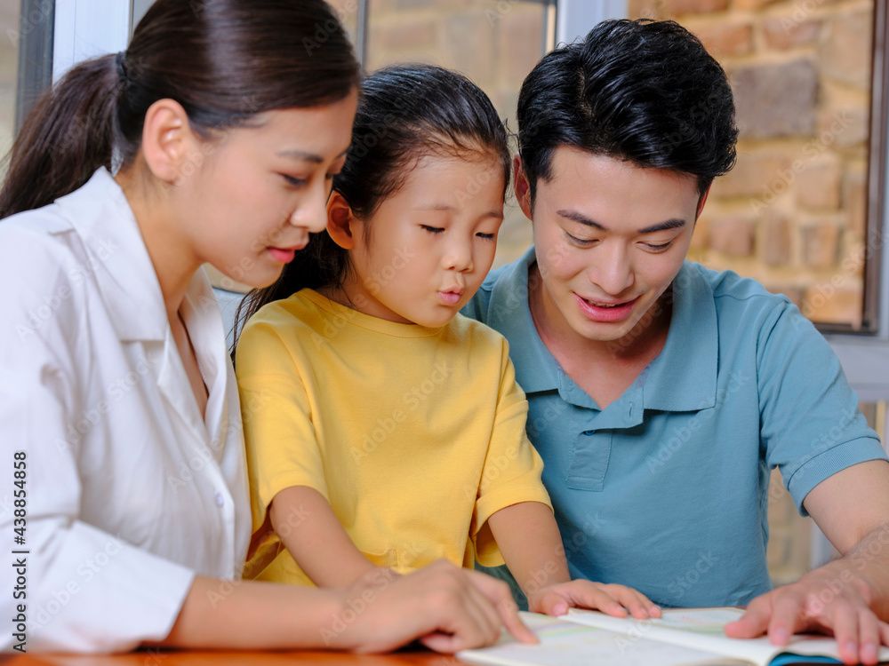 A Happy family of three reading together A Happy family of three reading together