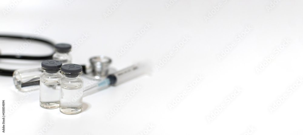 vaccine bottle, stethoscope and medical equipment with copy space on white background, coronavirus virus prevention, vaccination, medical technology, research laboratory, covid-19 vaccine concept vaccine bottle, stethoscope and medical equipment with copy space on white background, coronavirus virus prevention, vaccination, medical technology, research laboratory, covid-19 vaccine concept