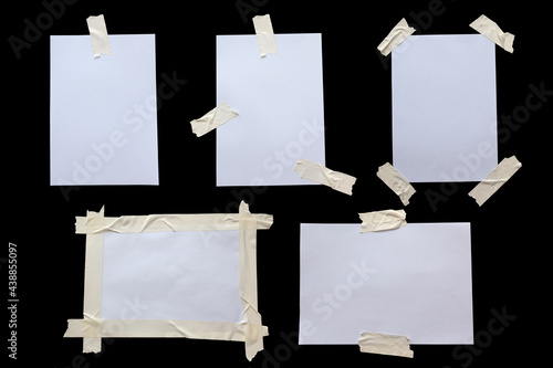 Variety of white paper stuck with sticky tape isolated on a white background.
