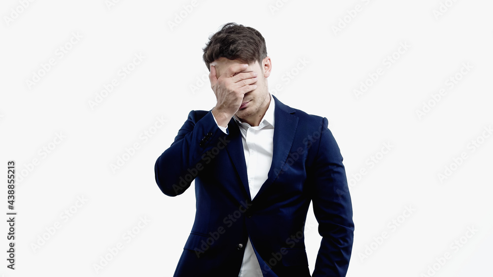 Businessman covering face with hand isolated on white Businessman covering face with hand isolated on white