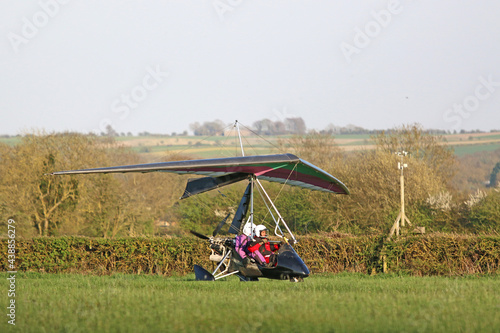 Ultralight airplane taking off from a grass strip	 photo