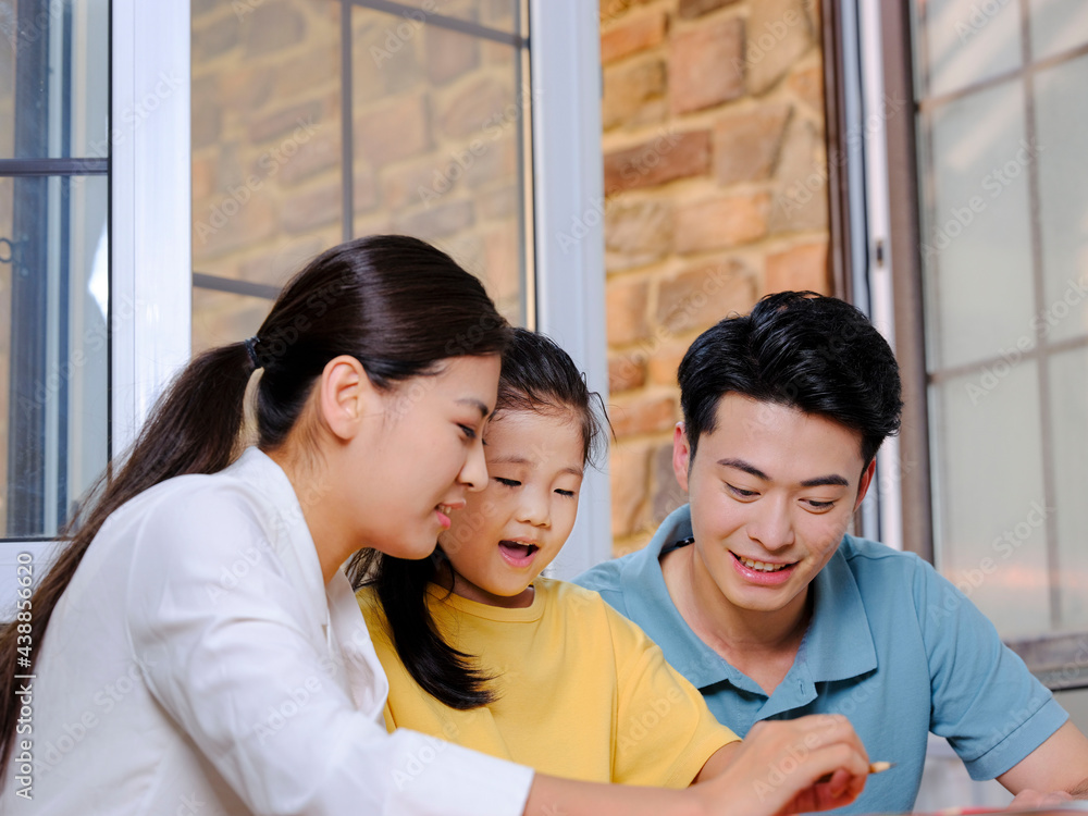 Young parents help their children with their homework