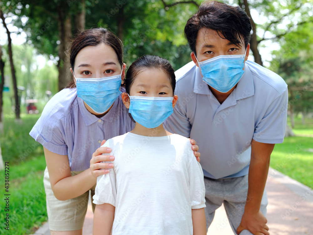 A young family of three with masks A young family of three with masks