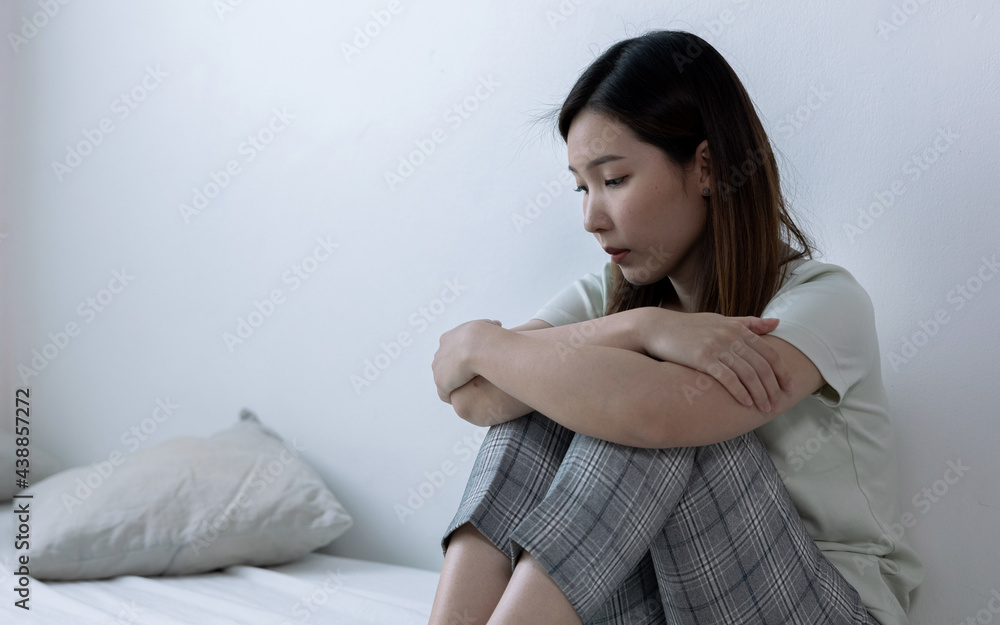 Teenage Asian girl with depression sitting alone in bedroom. Teenage Asian girl with depression sitting alone in bedroom.