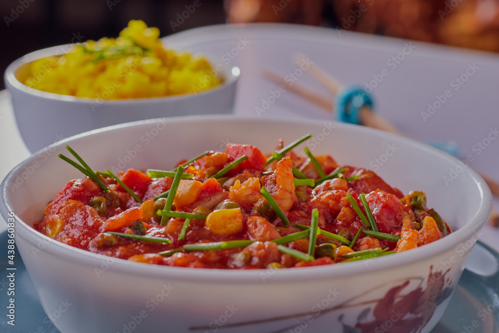 Prawn curry and rice garnished with chive. Prawn curry and rice garnished with chive.