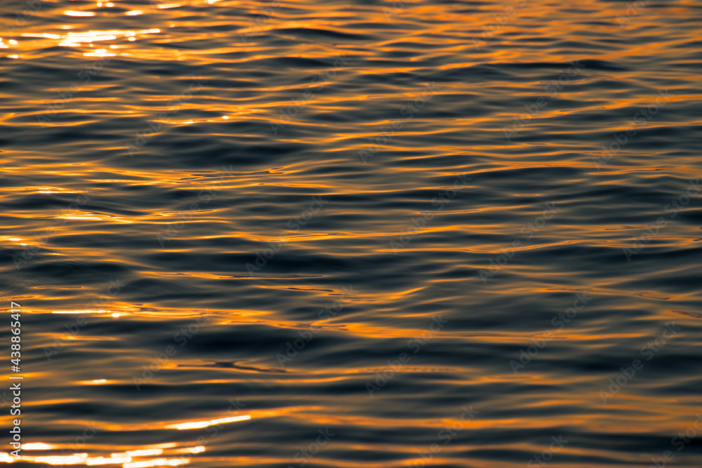 Quiet sea - texture. The sunrise is reflected in the sea water. Quiet sea - texture. The sunrise is reflected in the sea water.