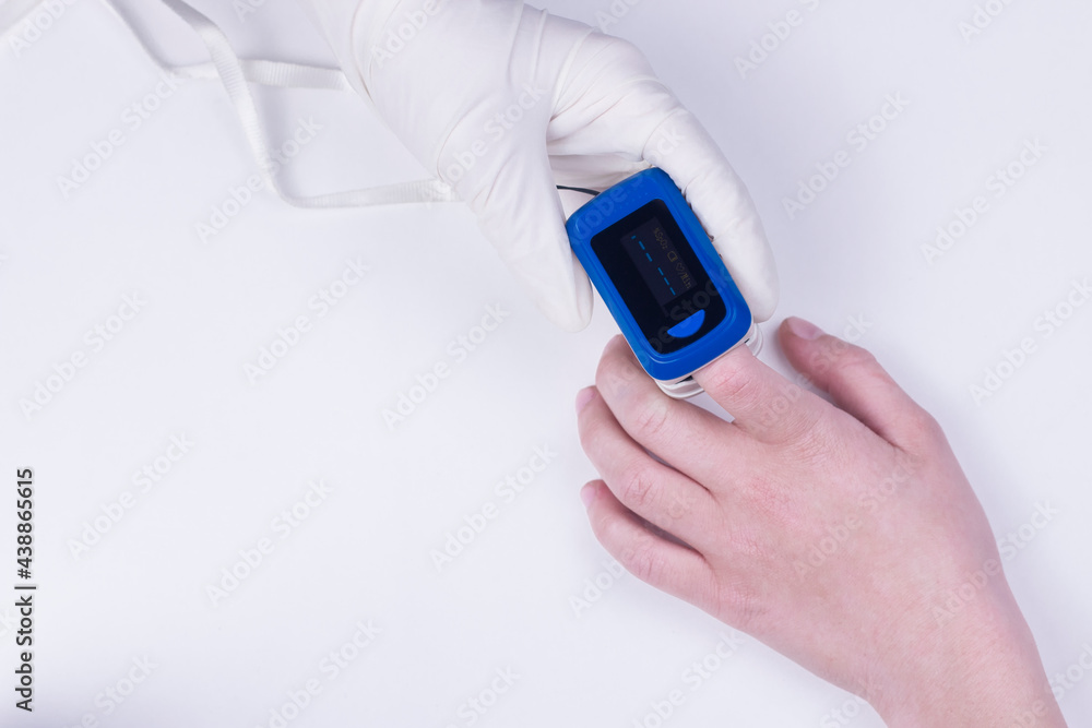 Doctor hand in white medical latex gloves hold patients hand with pulse oximetry on the finger. Noninvasive and painless oxygen saturation level test. Part of set. Doctor hand in white medical latex gloves hold patients hand with pulse oximetry on the finger. Noninvasive and painless oxygen saturation level test. Part of set.