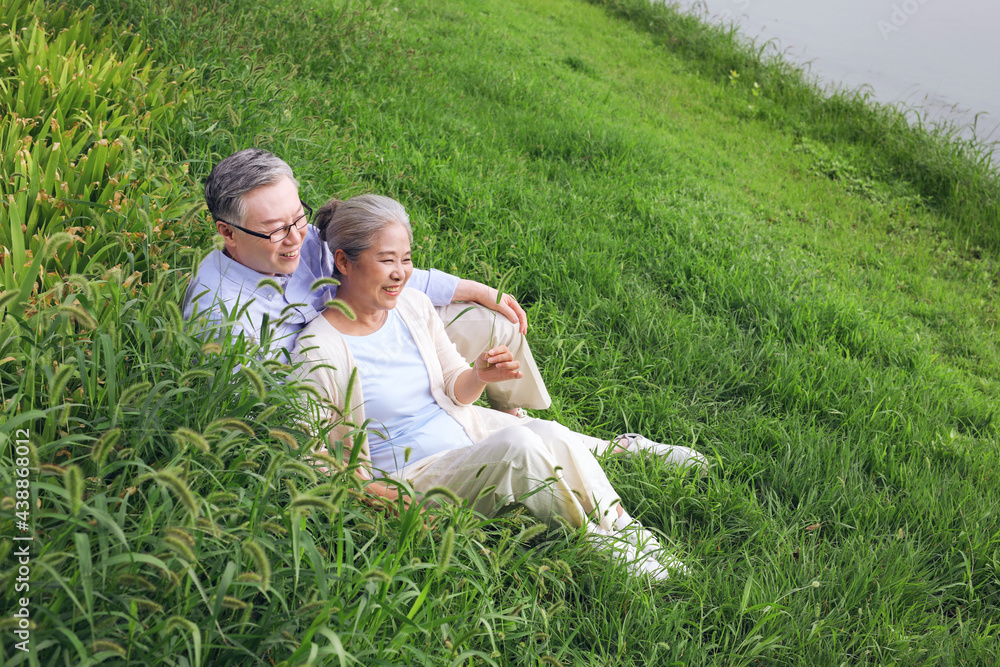 Happy old couple watching the scenery by the lake Happy old couple watching the scenery by the lake
