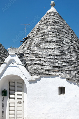 Alberobello, Puglia, Brindisi, Italy - july 19, 2017: View of the Famous village with typical dry stone Trulli houses and conical roof. Trulli picturesque street in the old town. Cone-roofed houses