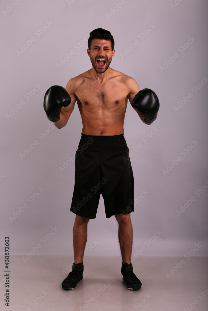 Fighter with boxing gloves on grey background