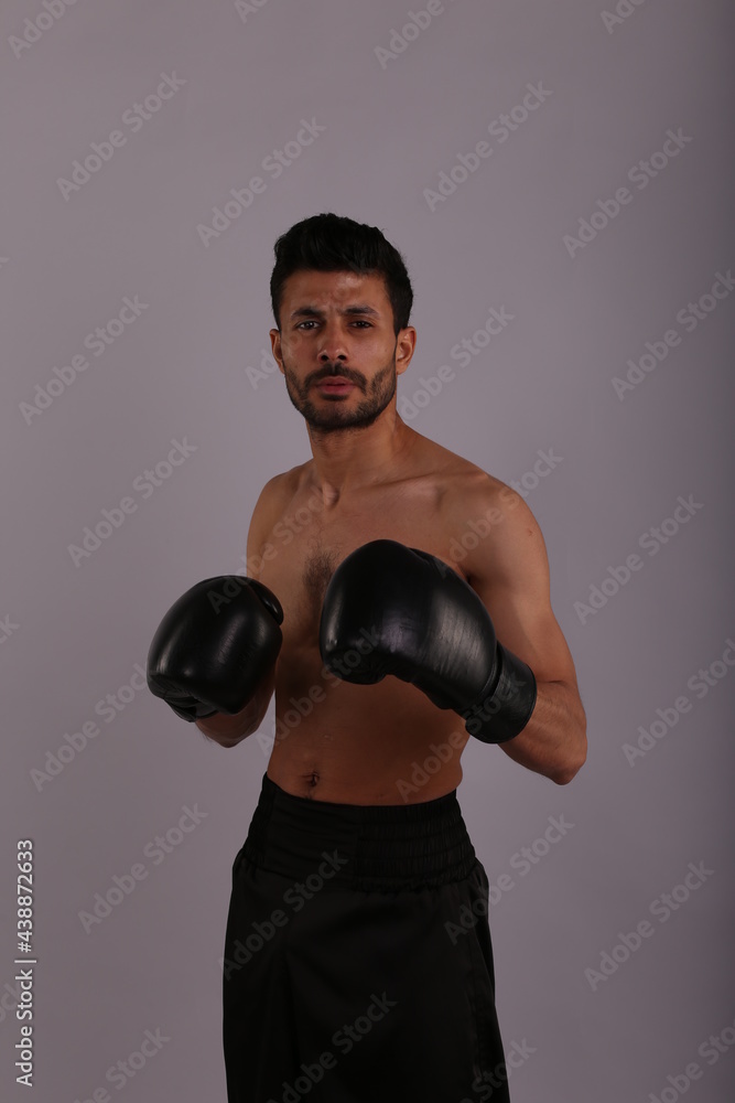 Fighter with boxing gloves on grey background