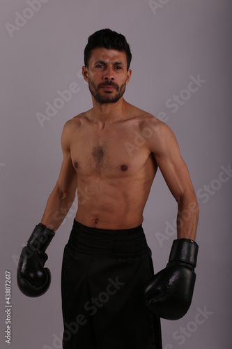 Boxer in boxing gloves on gray background