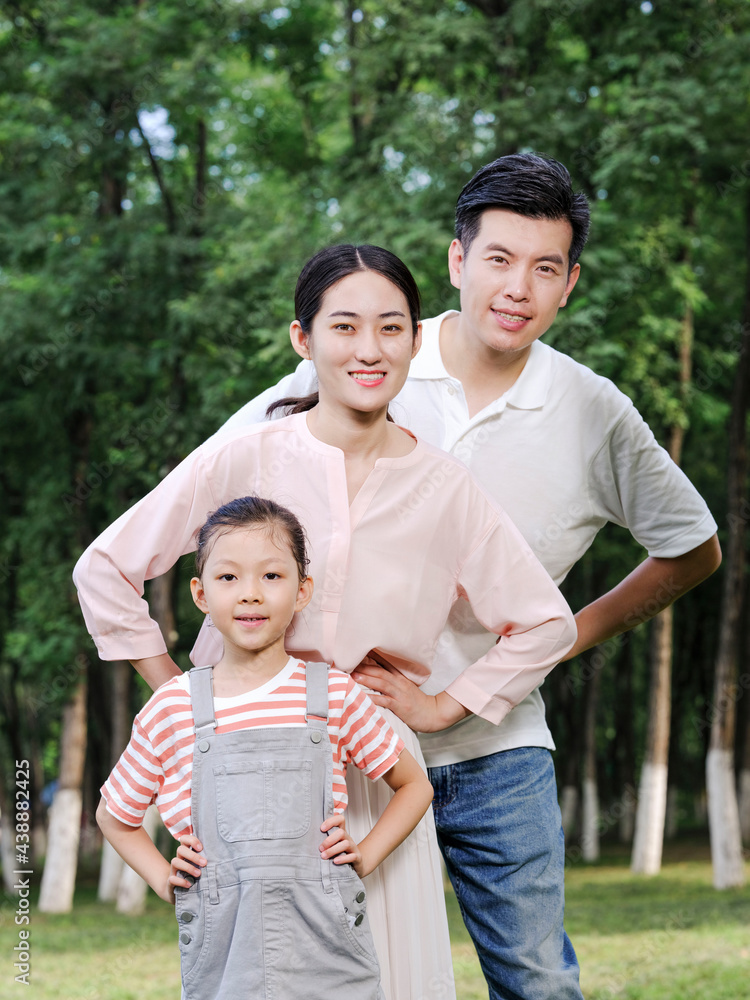 Happy family of three playing in the park Happy family of three playing in the park