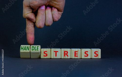 Handle stress symbol. Businessman turns cubes and changes words 'stress' to 'handle stress'. Beautiful grey background. Medical, psychological, handle stress concept. Copy space.
